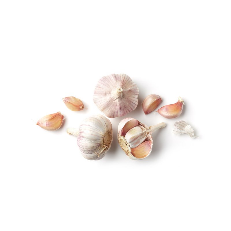 Life Extension, three heads of garlic with one's separated cloves, scattered, in center of image on white background